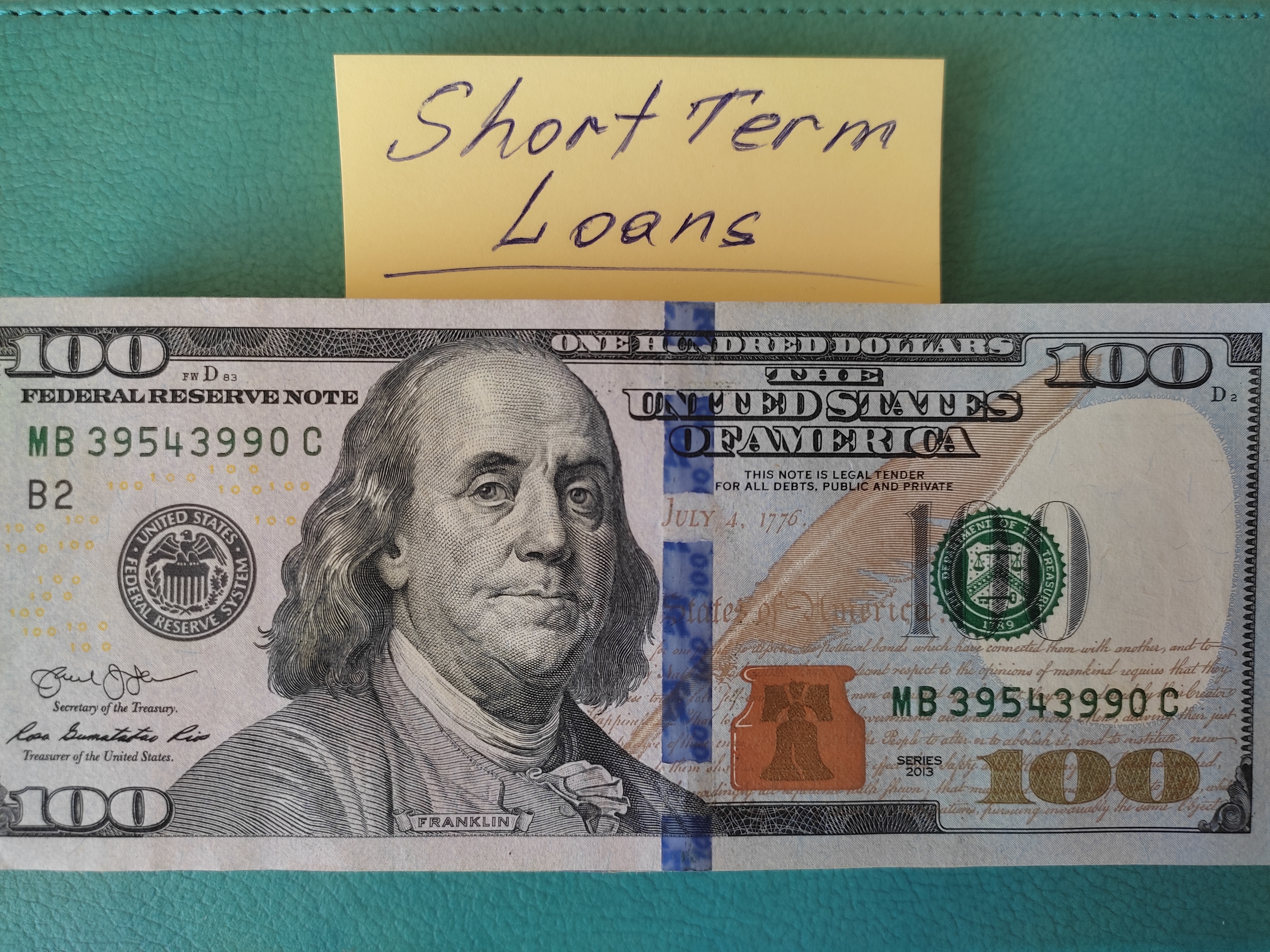 There are dollars and a yellow sticker on the table that says short term loans.